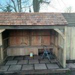 COLIN'S SUMMERHOUSE PROUDLY SITS ON A TILED FLOOR EDGED WITH NEW RAILWAY SLEEPERS