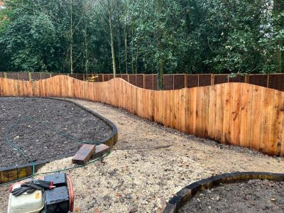CURVED PLAQUE WALL MADE FROM RAILWAY SLEEPERS IN HOSPITAL MEMORIAL GARDEN