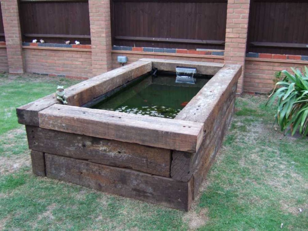 Raised pond & water feature built from used tropical hardwood Azobe railway sleepers. Railwaysleepers.com 