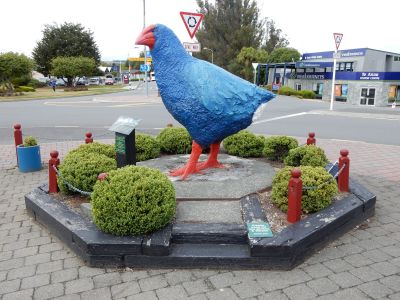 IS THAT AN OVERSIZED BLUE CHICKEN ON A RAILWAY SLEEPER RAISED BED?