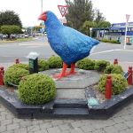 IS THAT AN OVERSIZED BLUE CHICKEN ON A RAILWAY SLEEPER RAISED BED?