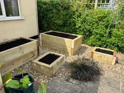 A VARIED COLLECTION OF RAISED PLANTERS FROM NEW PINE RAILWAY SLEEPERS